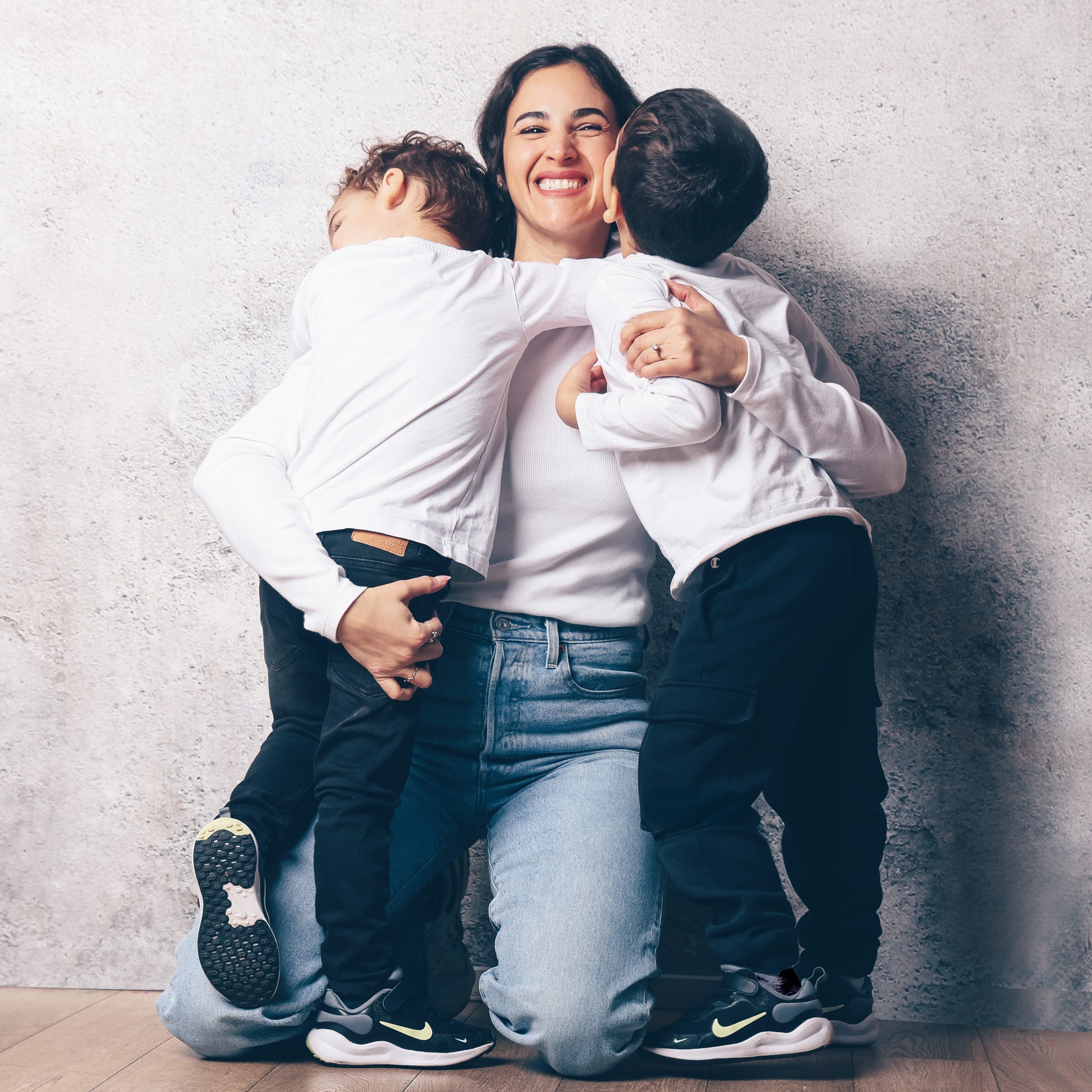 Mother hugging her kids