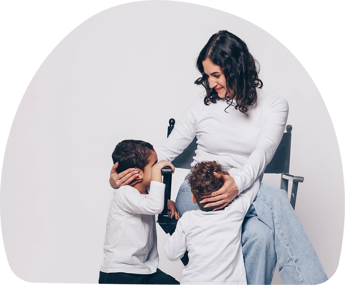 MOMent founder standing with her two young sons, backs turned, representing support for mothers