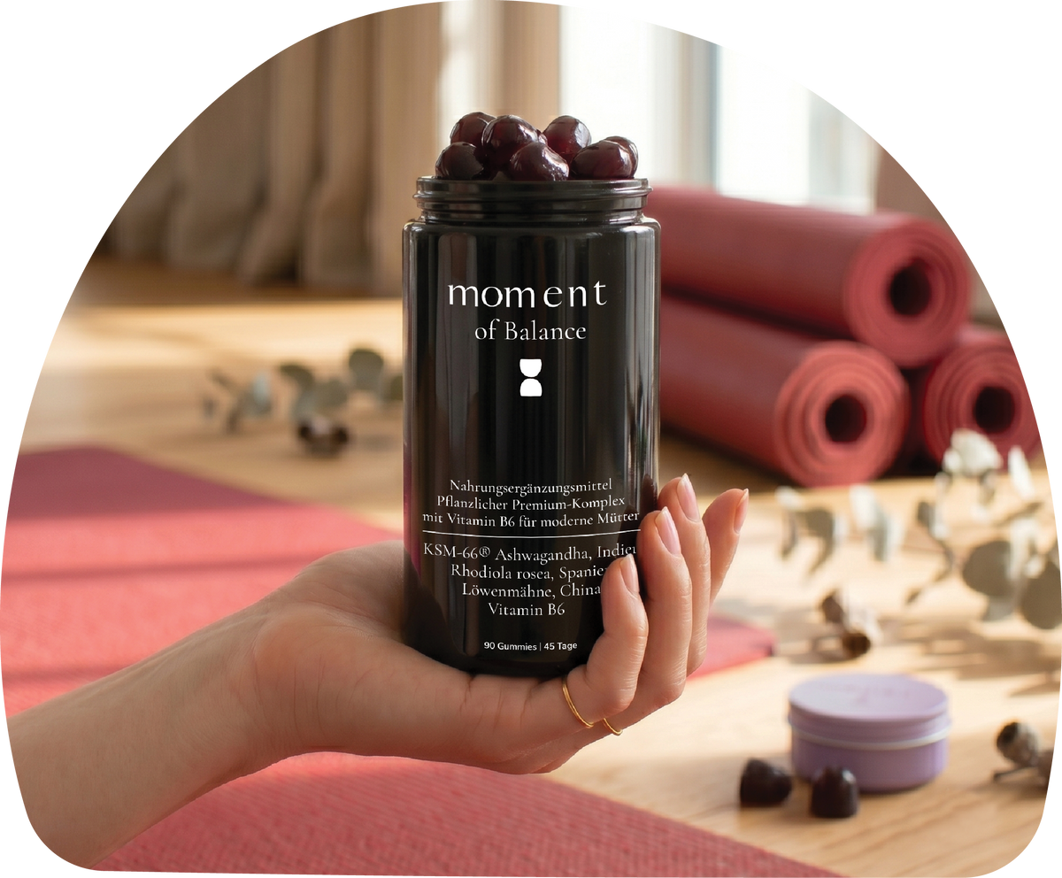 MOMent of Balance supplement jar. Wellness shoot, hand holding the jar, with yoga studio background.
