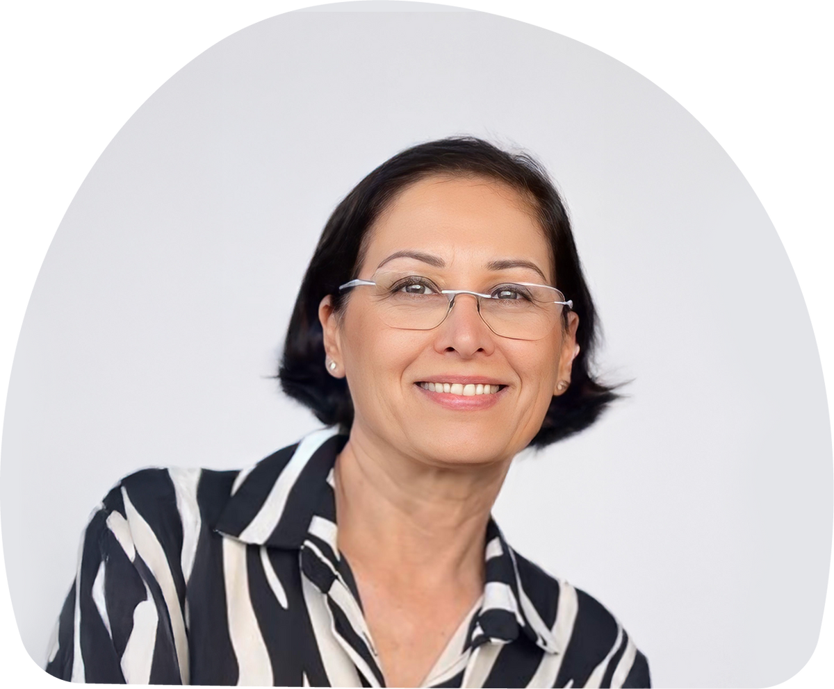 Close-up portrait of Dr. Riki Langberg, MOMent formulation consultant, with a white-grey background